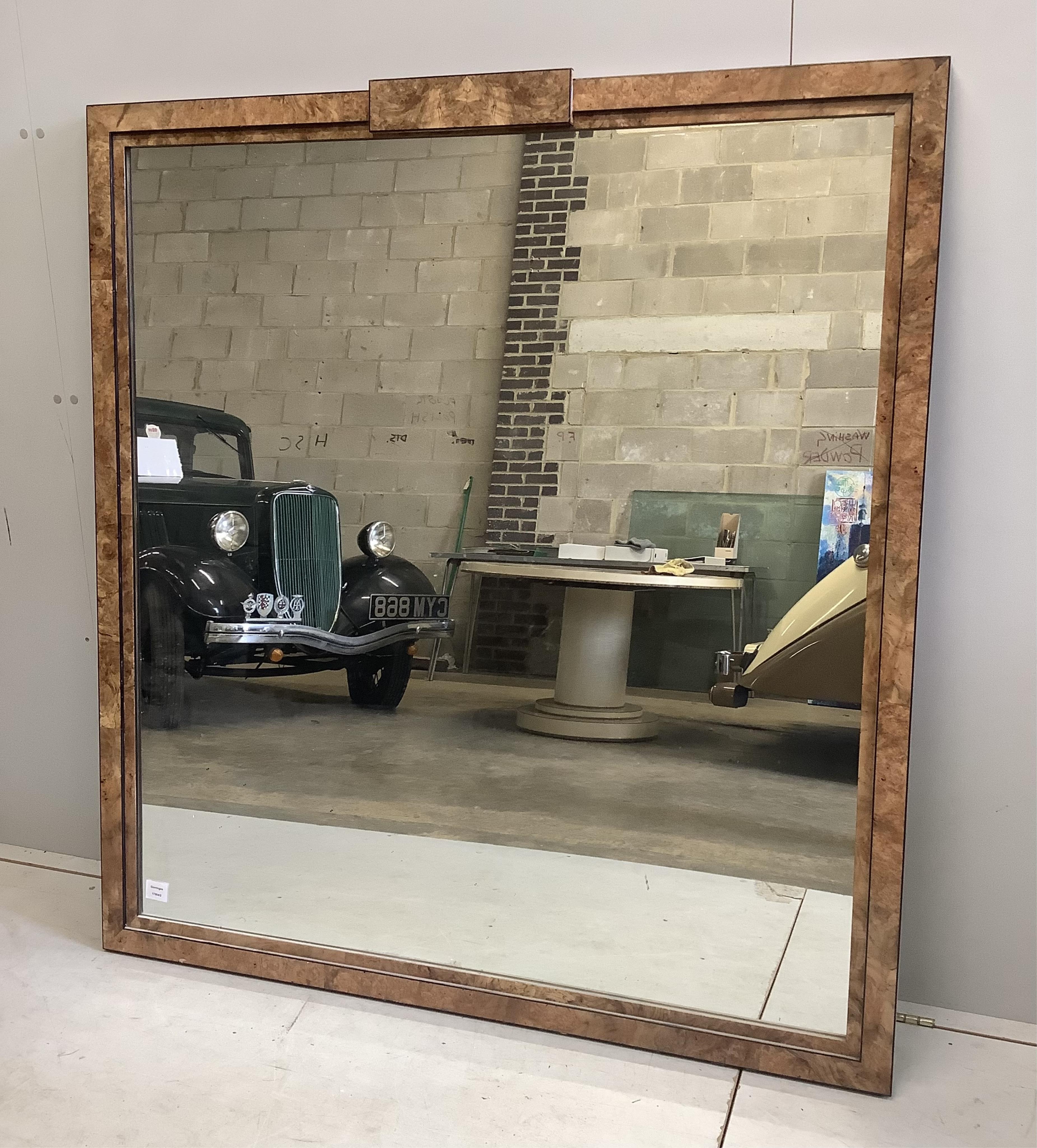 An Art Deco style sweetgum veneered rectangular overmantel mirror